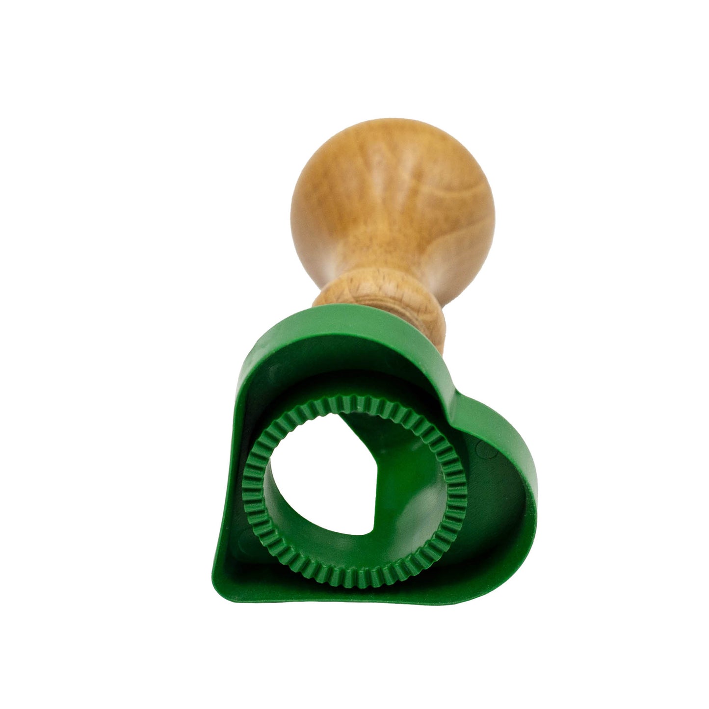 Green plastic heart shape biscuit and pasta cutter with wooden handle.